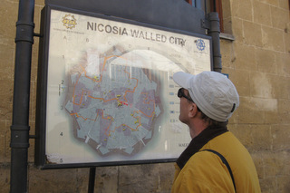 Richard studying a map on the wall