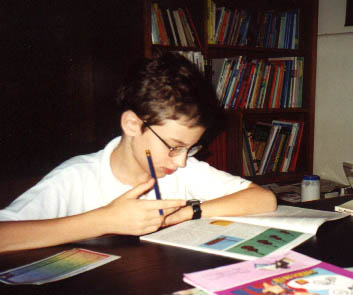 Timothy working on ACE paces (or workbooks) at the table