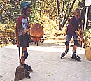 Daniel and Tim playing creative 'roller-hockey' using brooms in the back yard