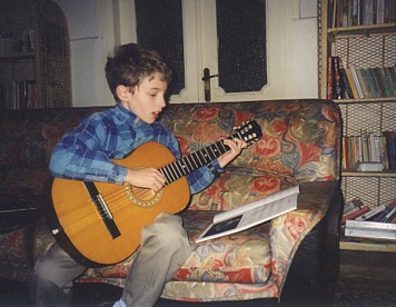 Tim playing his guitar and singing