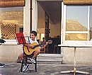 Tim sings with his guitar